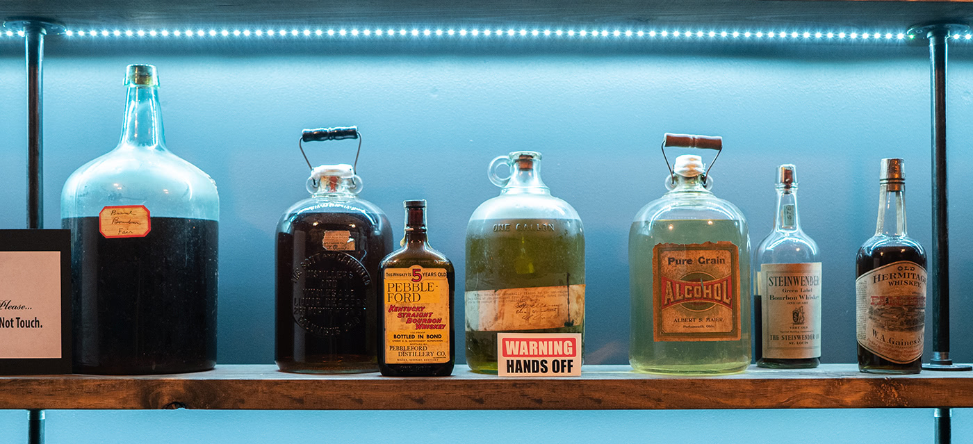 Strange and unusual vintage spirits line the walls of the library