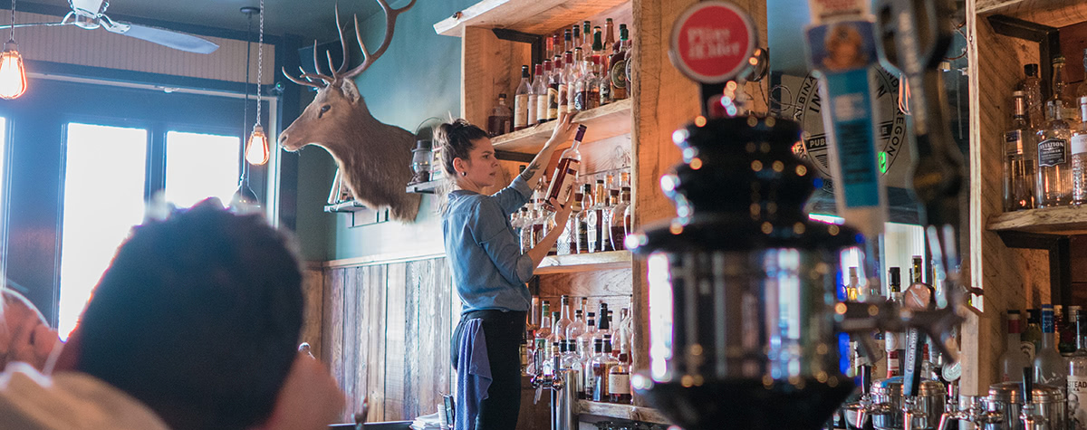 The bartender inspects a 23 year old Willett bourbon